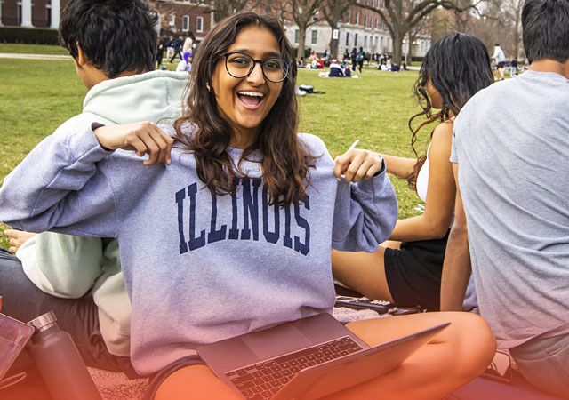 student proudly displaying an Illinois sweatshirt on the Quad