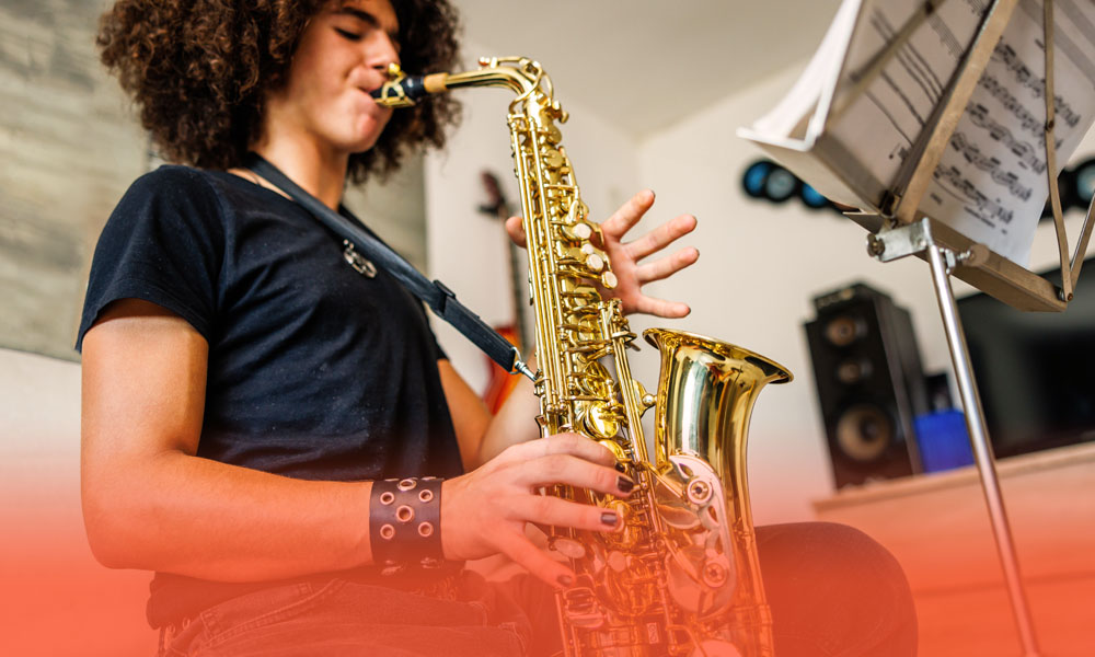 high school student practicing the saxophone at home