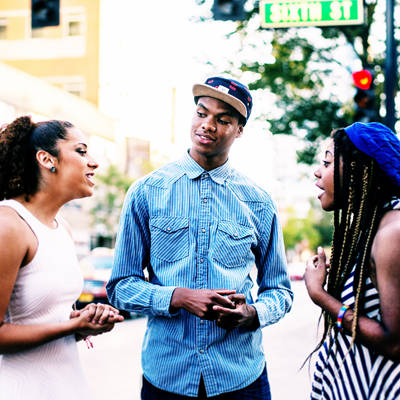 a group of students talking along Green Street