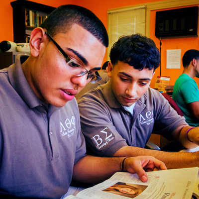 two fraternity members studying together