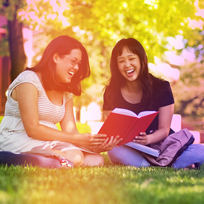 students sharing a book