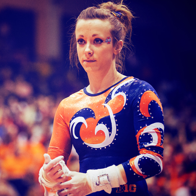 an Illinois female gymnast awaiting her turn at a meet in Huff Hall
