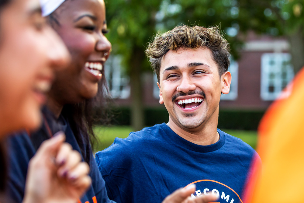 smiling group of students wearing orange and blue