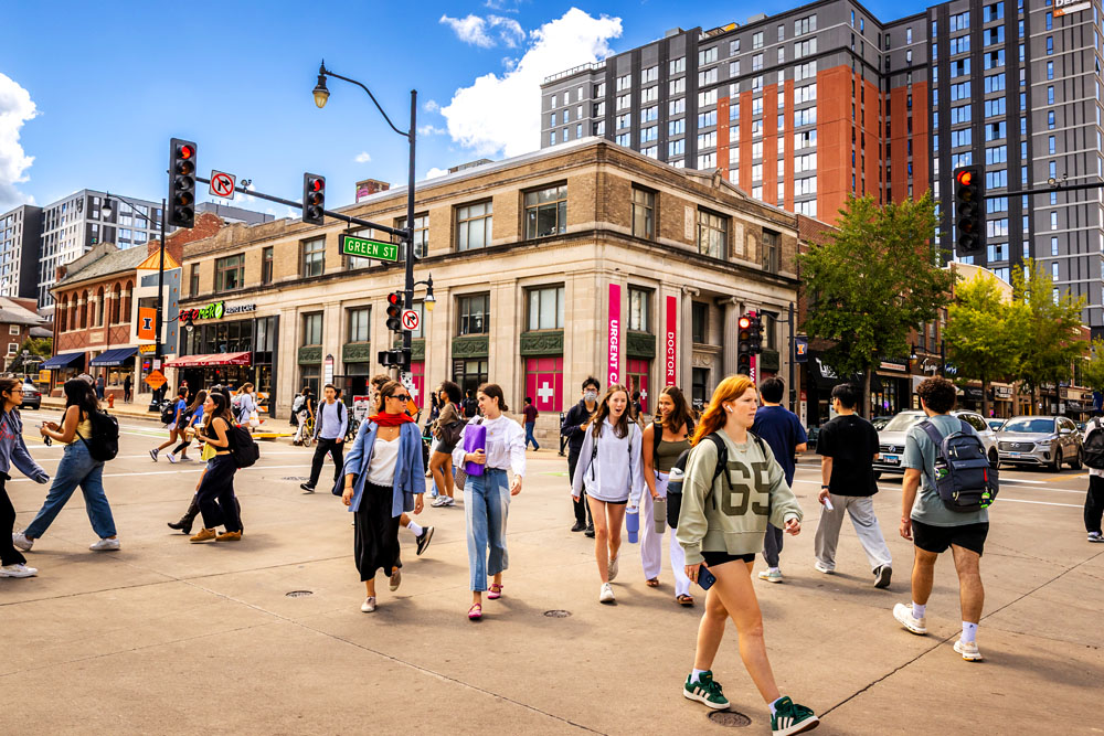students crossing at the intersection of Green and Wright Street in campustown