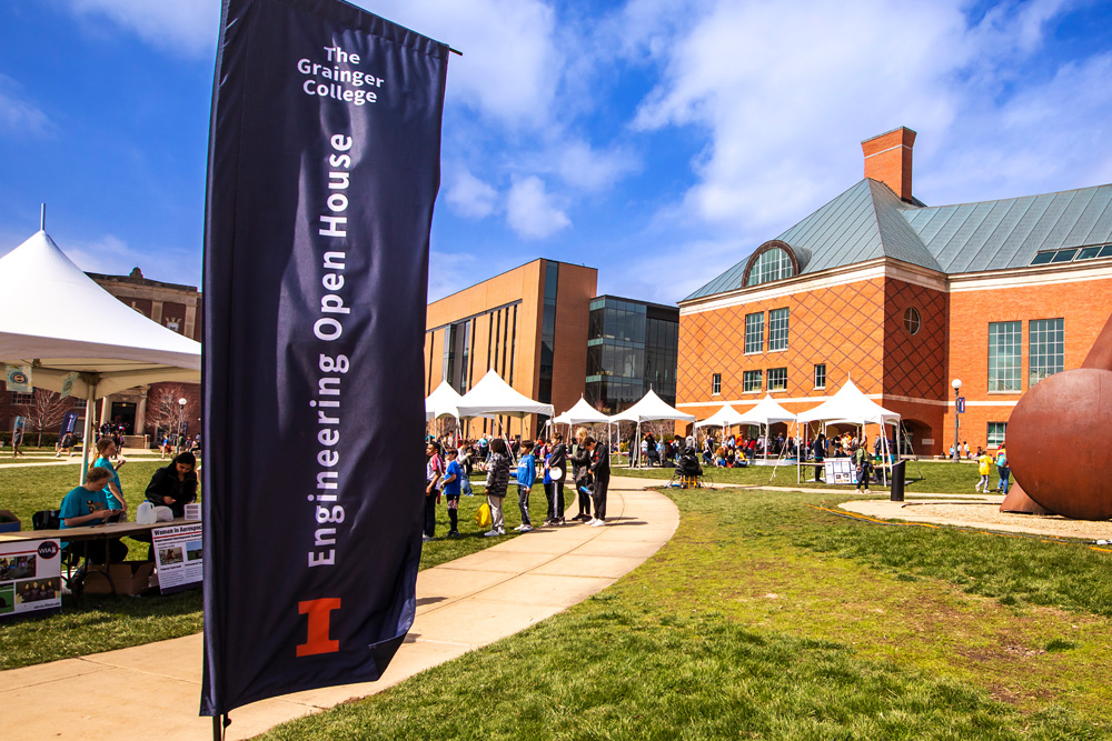 banner for the Grainger College of Engineering Open House, visitors check out various tents across the Bardeen Quad