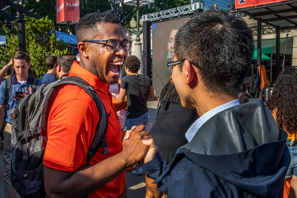 friends find one another and embrace at Illini Fest celebration in Chicago