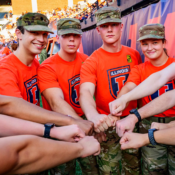 ROTC members hands-in on the field at Illinois football game