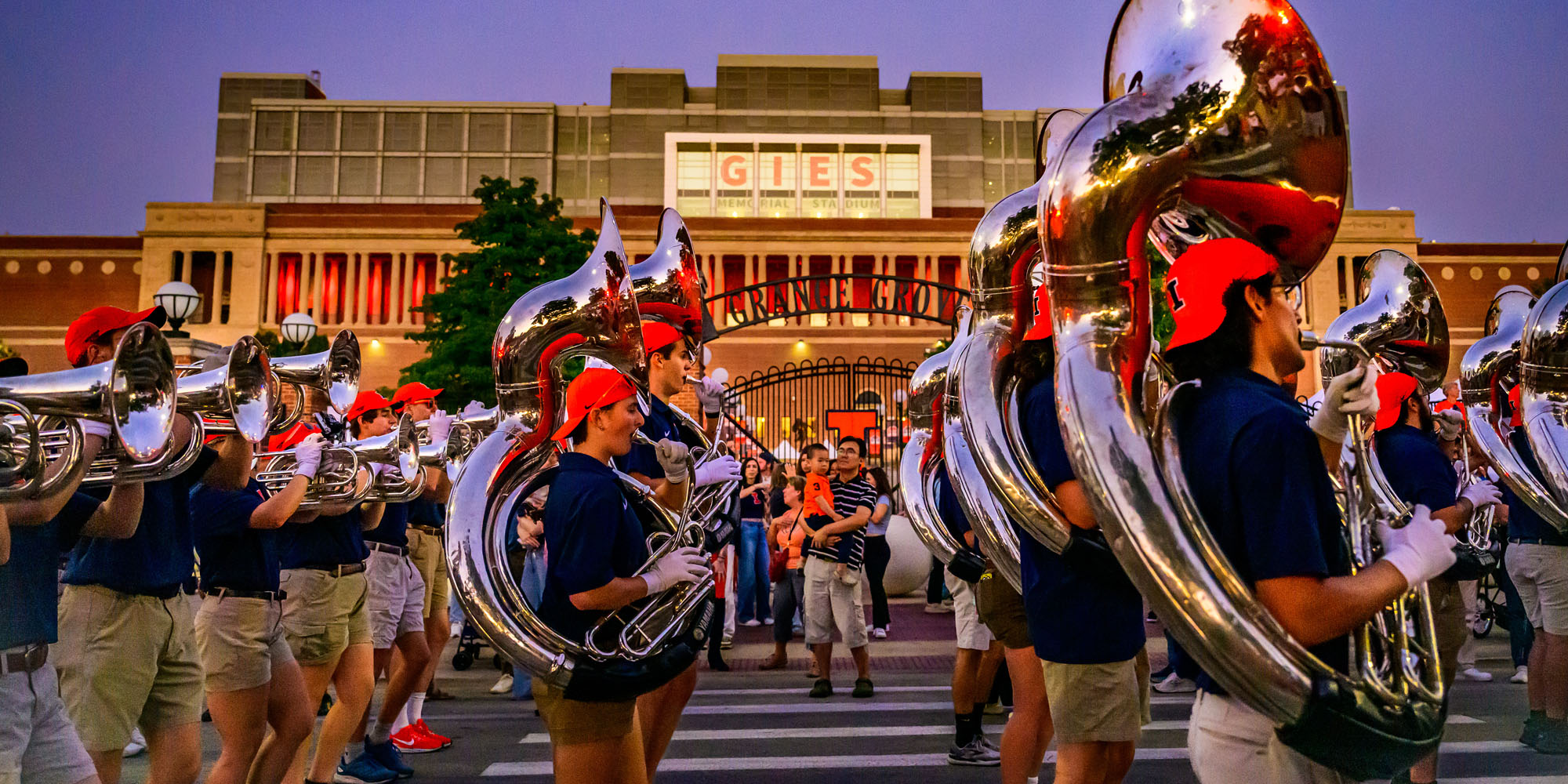 members of the Marching Illini take part as students, alumni and community gather for the Illinois Homecoming Parade