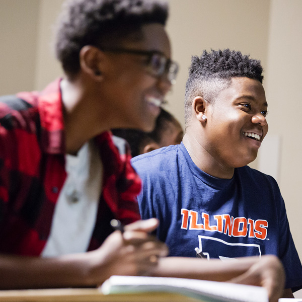 smiling students listen intently to psychology class, part of the Access and Achievement Program