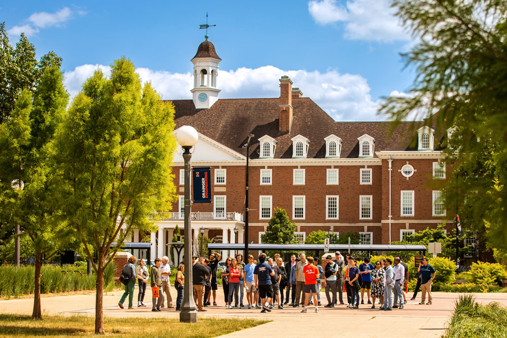 summer campus tour group stops outside Illini Union