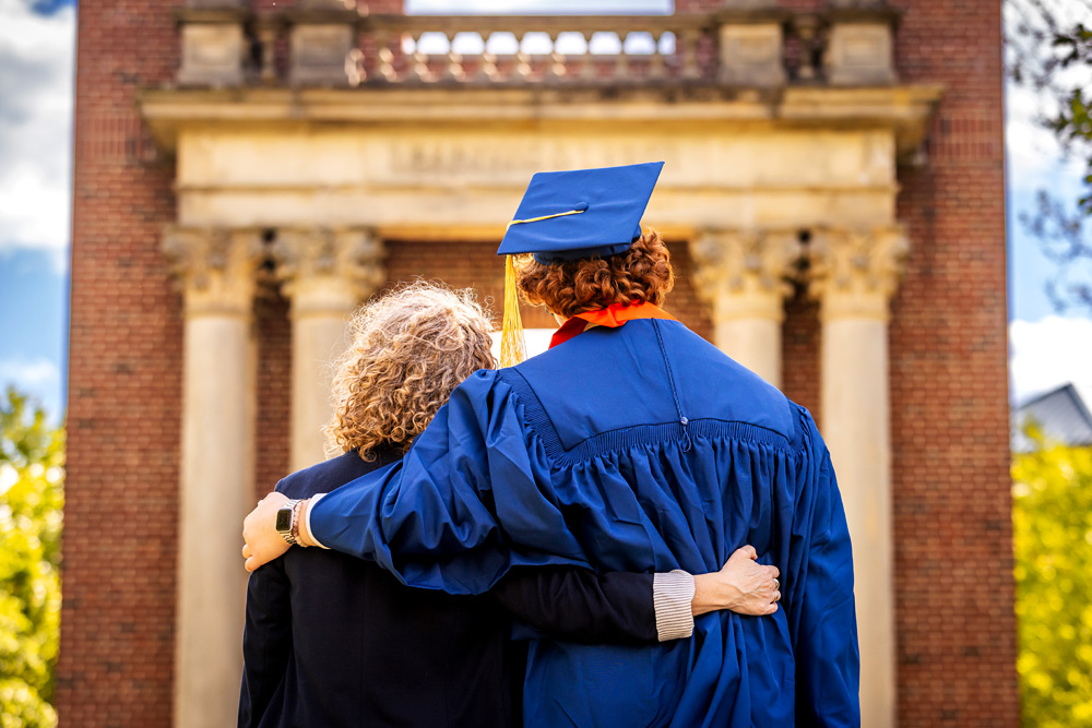 the backs of a mother and graduating son hugging and viewing the Hallene Gateway